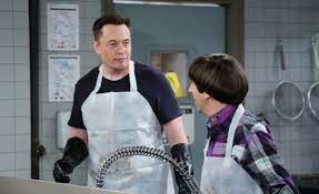 Elon Musk wearing white apron on the Big Bang Theory