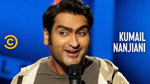 Kumail Nanjiani's face, speaking into microphone